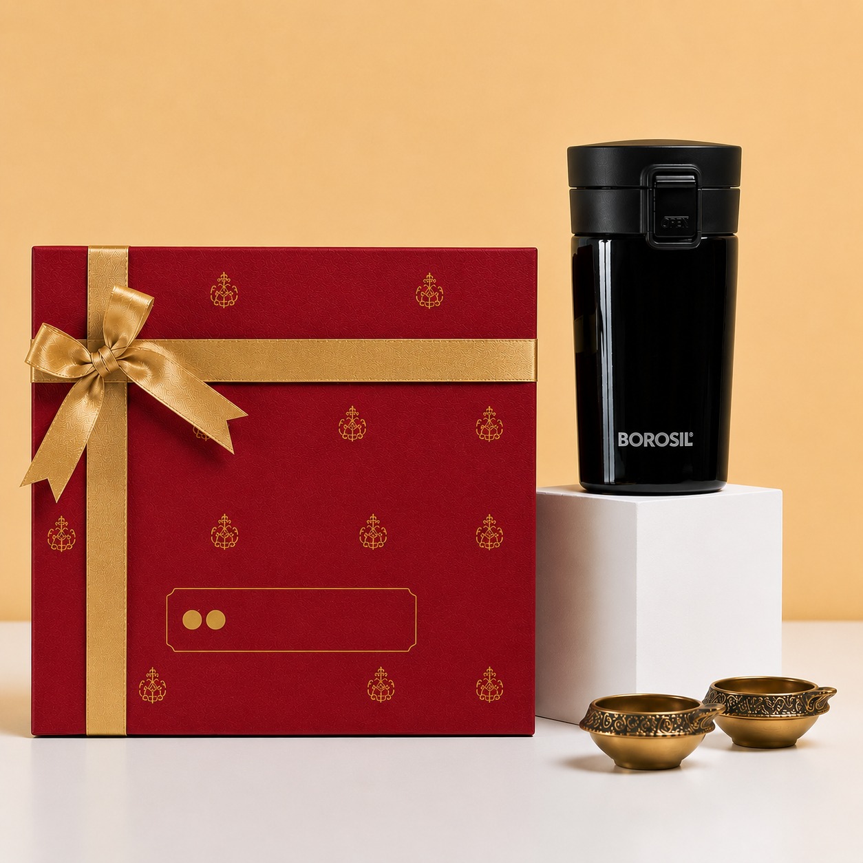 Red and gold festive gift box with Borosil flask and brass diyas